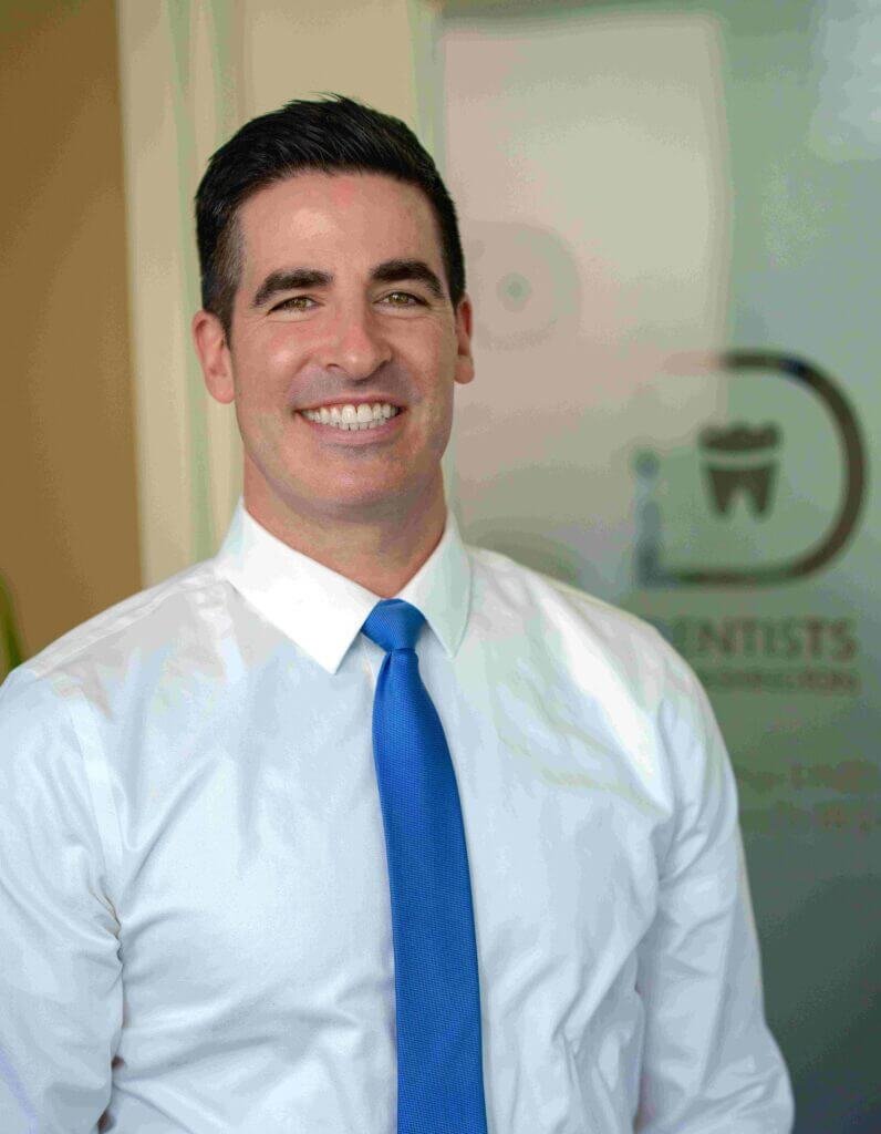 Friendly dentist performing a professional oral health examination in Philadelphia.